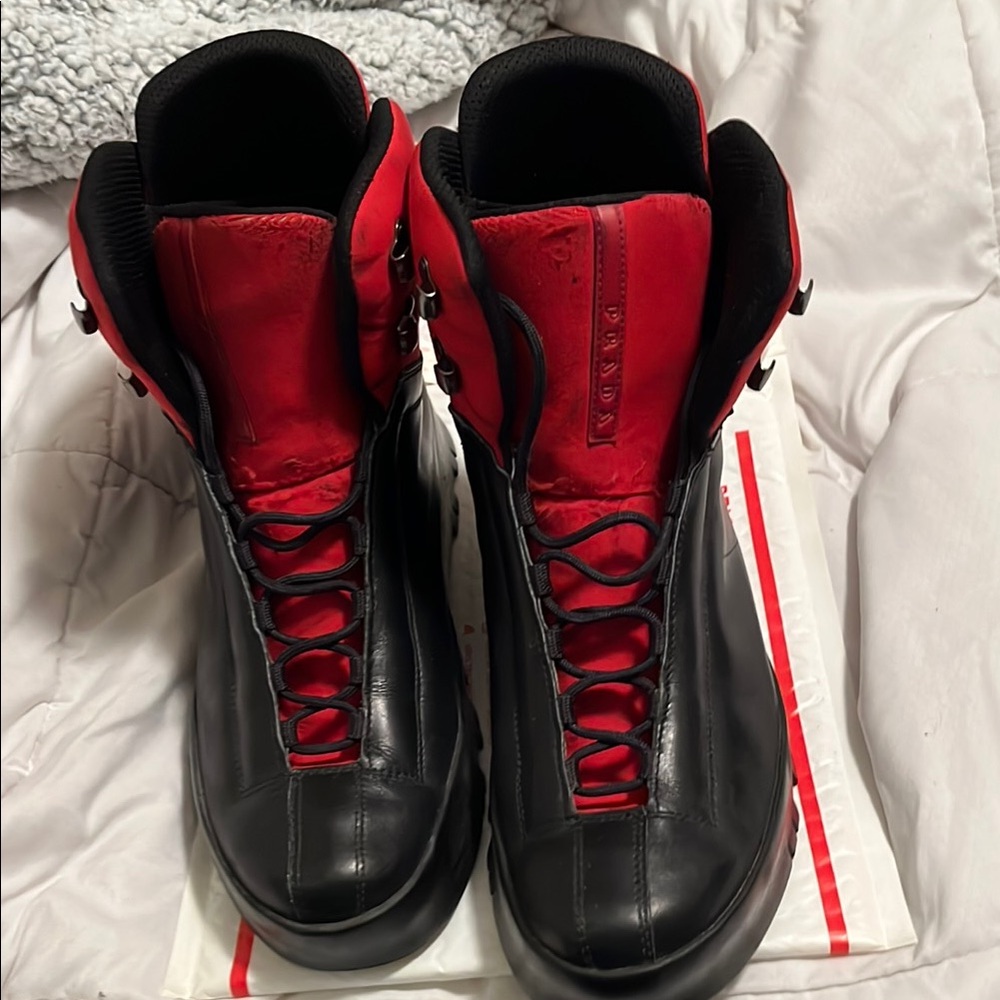 Men's Black and Red Prada boots UK 9 = US Size 10
Used but a lot of life left.